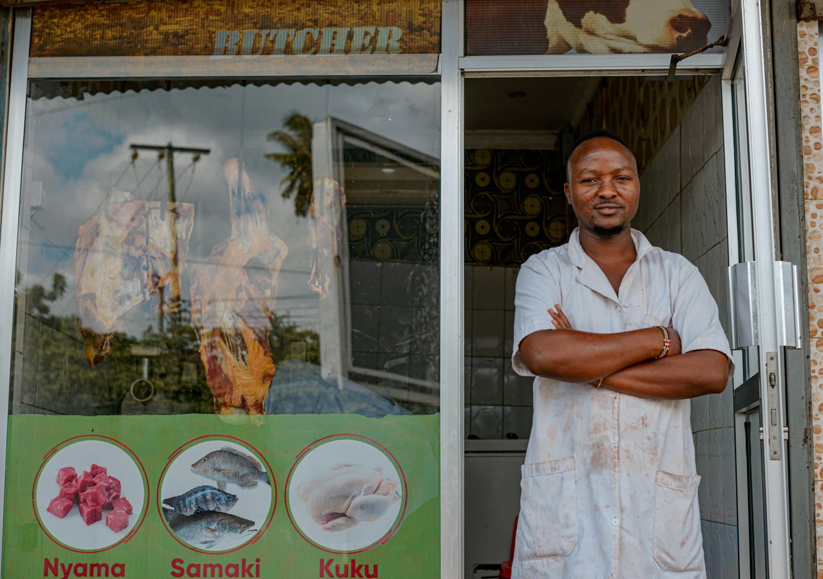 Local shop owner standing in the doorway of his store