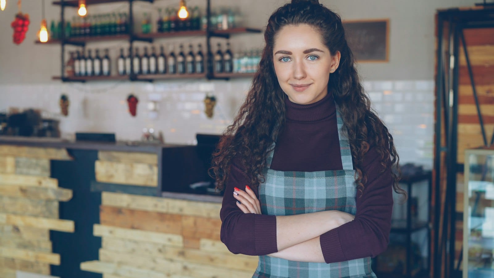Small business owner standing in her café