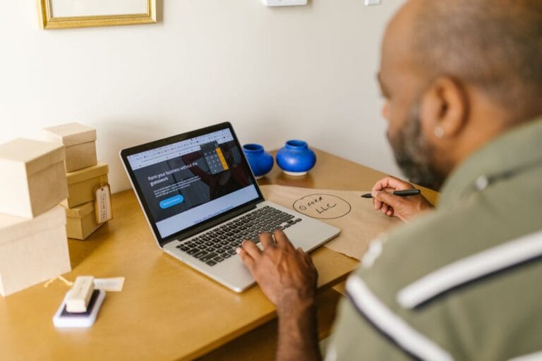 Small business owner reviewing a website redesign on a laptop